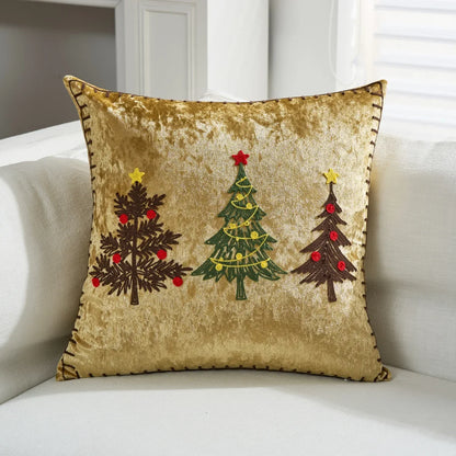 Decorative pillow with Christmas tree designs on a white couch. Embroidered Merry Christmas pillow cover with snowflake design – festive red and white holiday cushion for sofa or bedroom décor.