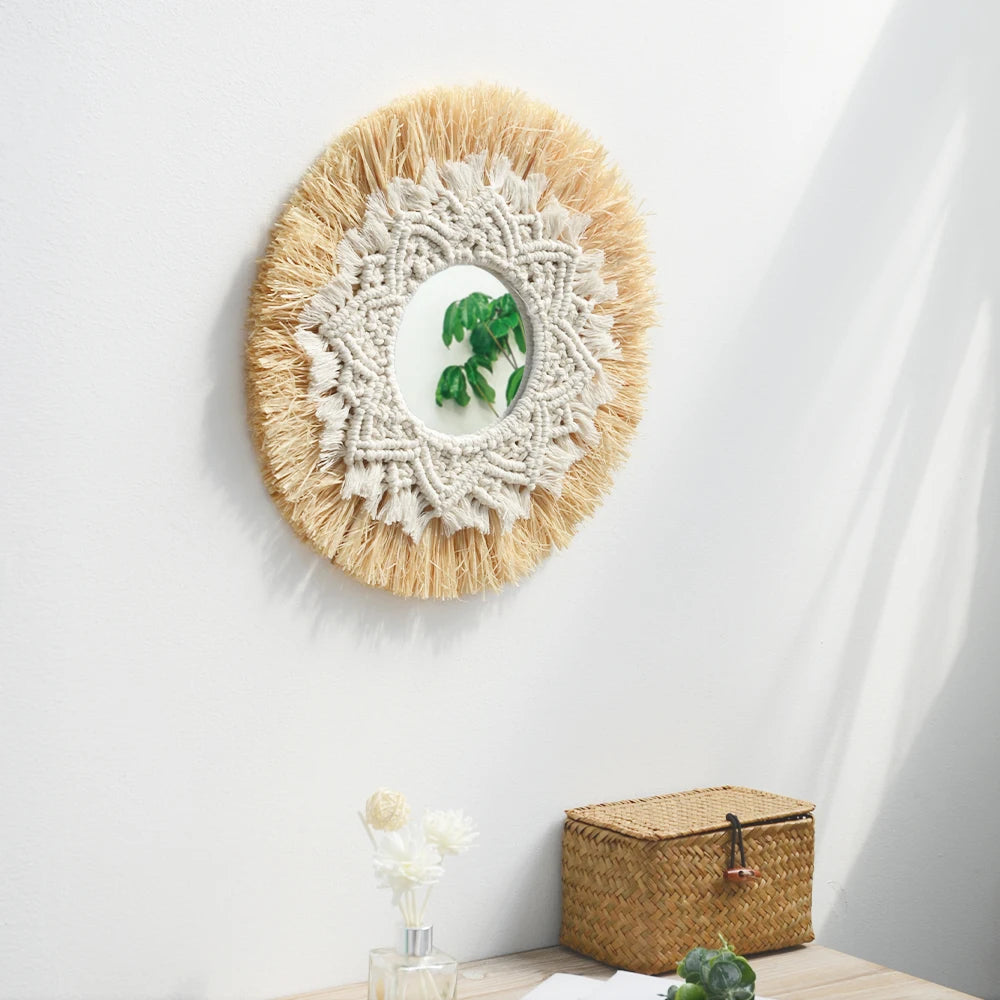 Round decorative mirror with macrame design on a white wall, with a small plant and basket in the foreground. boho home decor, boho wall mirror, macrame wall mirror, nordic decor, romantic wedding wall decoration, housewarming gift, round straw mirror, woven wall decor, tapestry mirror, boho bedroom wall accent, rustic mirror wall hanging