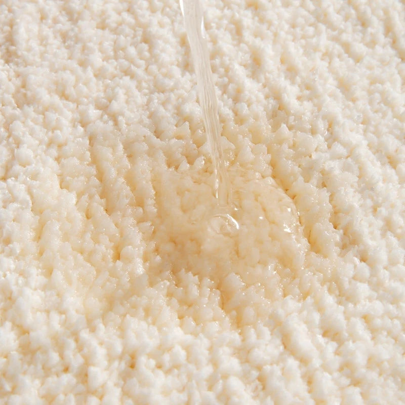 Close-up of a stream of water flowing over a textured beige surface boho home decor, bathroom rug, tufted bath mat, Get Naked rug, colorful shower mat, apartment decor, dorm bathroom accessories, housewarming gift, microfiber bath mat, fun bathroom rug, American style bath mat