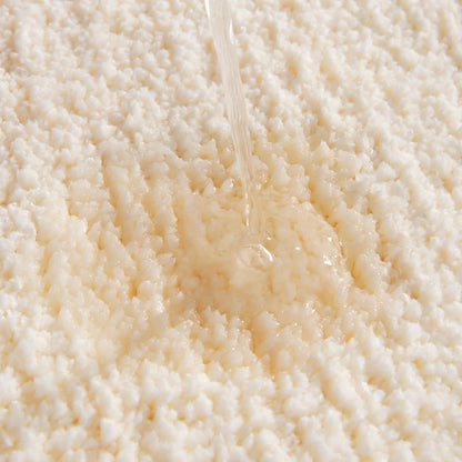 Close-up of a stream of water flowing over a textured beige surface boho home decor, bathroom rug, tufted bath mat, Get Naked rug, colorful shower mat, apartment decor, dorm bathroom accessories, housewarming gift, microfiber bath mat, fun bathroom rug, American style bath mat