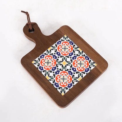 Wooden cutting board with floral patterned square on a white background