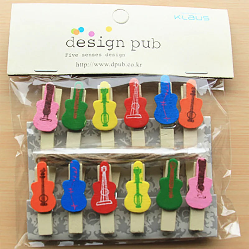 Colorful guitar-shaped paper clips in a clear package with 'design pub' branding.
