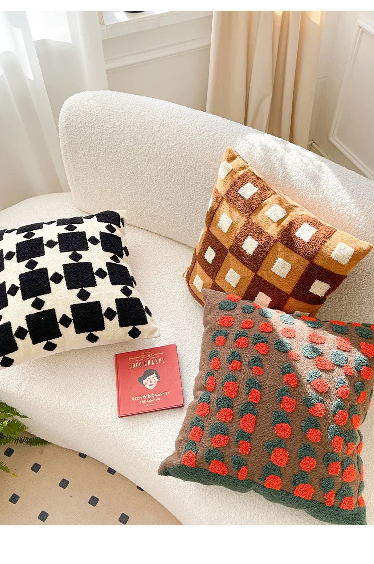 Decorative pillows with geometric patterns on a sofa. Bohemian embroidered throw pillow cover 18x18 inch with geometric towel embroidery, decorative cushion for sofa, bed, or living room boho home decor