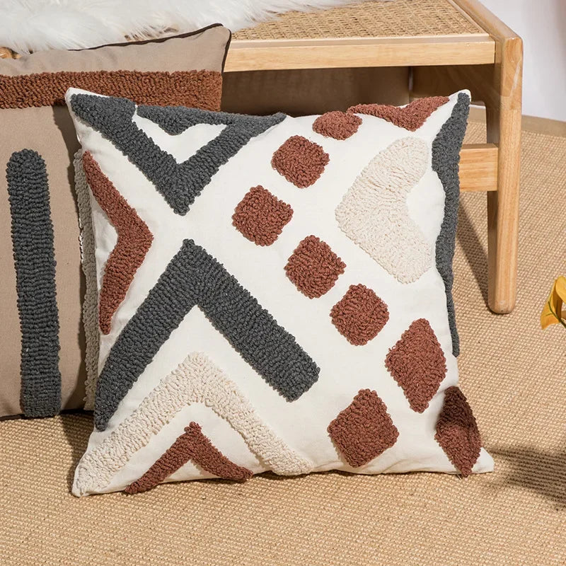 Decorative pillow with geometric pattern on a beige surface Nordic blue tufted cushion cover with geometric stripe and grid crochet pattern, tassel pillow cover for sofa, bed, and boho home decor