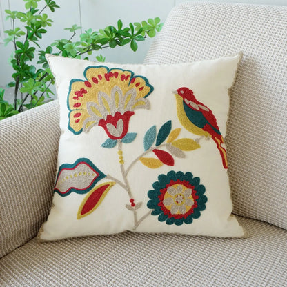 Decorative pillow with floral and bird patterns on a beige couch. Floral embroidered throw pillow cover boho decor
