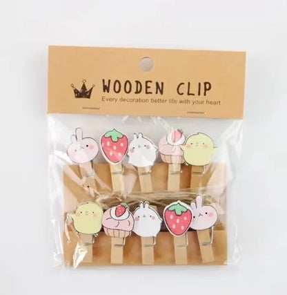 Packaged wooden clips with cartoon designs on a white background