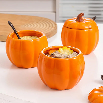 Three orange pumpkin-shaped containers with lids on a white surface. Pumpkin-shaped ceramic bowl with lid kitchen container Halloween and Thanksgiving fall serving dish