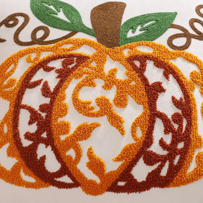 Embroidered pumpkin design on fabric with orange, brown, and green colors. Velvet pillow cover with embroidered pumpkins, sunflowers, and autumn leaves – cozy fall home décor for sofa or living room.