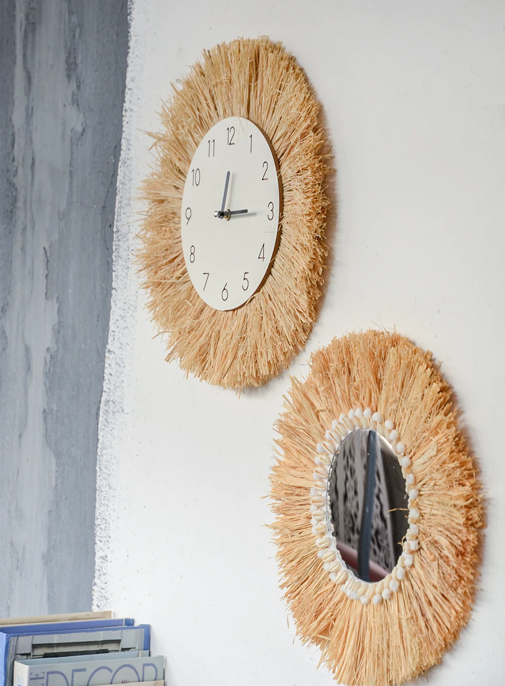 Two decorative wall pieces, one with a clock face and the other with a mirror, on a white wall. boho home decor, boho wall mirror, macrame wall mirror, nordic decor, romantic wedding wall decoration, housewarming gift, round straw mirror, woven wall decor, tapestry mirror, boho bedroom wall accent, rustic mirror wall hanging