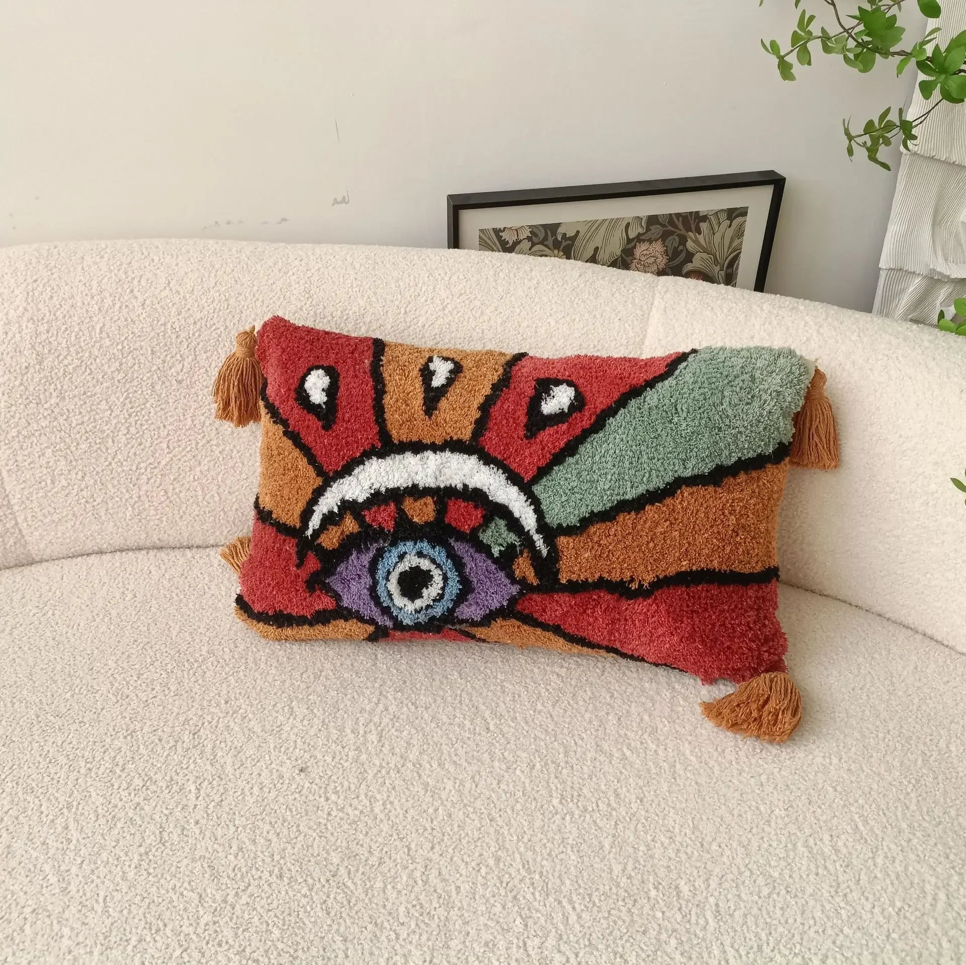 Colorful patterned pillow on a beige sofa with a neutral background Boho Devil's Eye embroidered pillow cover with tufted geometric design in cotton blend fabric, decorative cushion for sofa, bed, or living room boho home decor.
