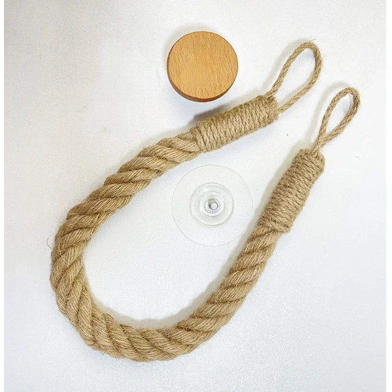 Rope with a wooden disc and plastic button on a white background. Boho rope toilet paper holder, nail-free wall mounted paper towel rack, rustic bathroom storage and decor accessory with wood and rope design