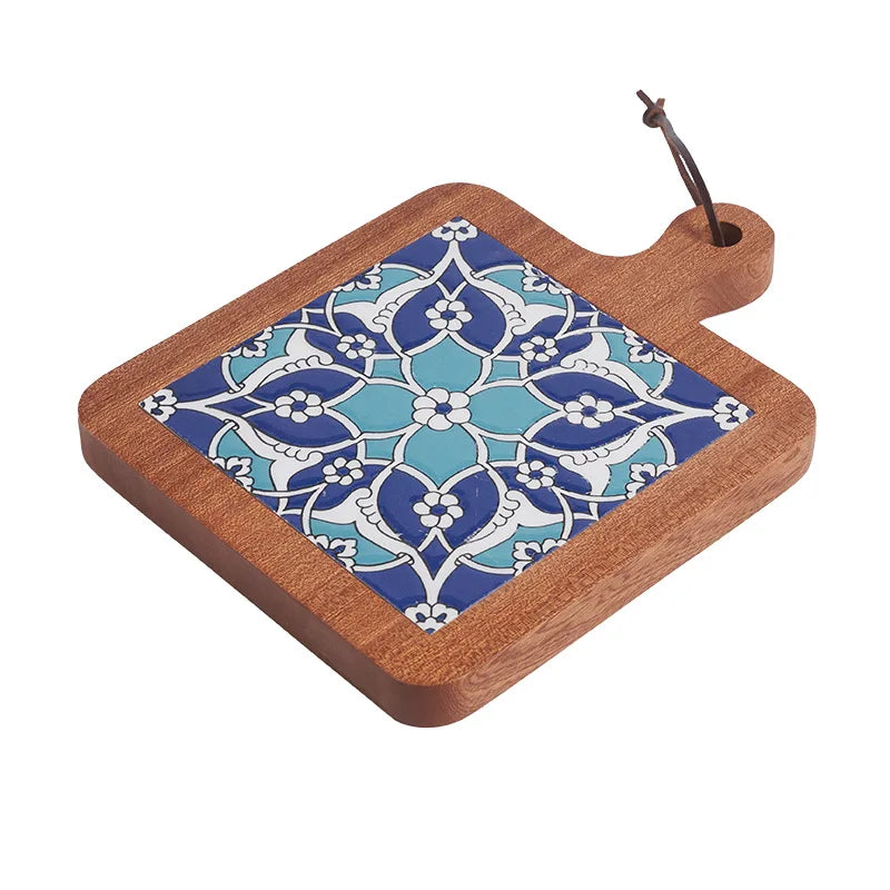 Wooden cutting board with blue floral pattern on a white background