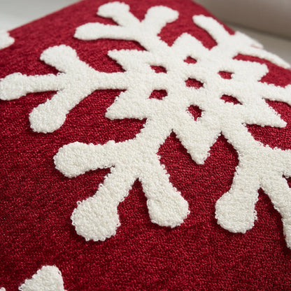 Red fabric with white snowflake patterns. Embroidered Merry Christmas pillow cover with snowflake design – festive red and white holiday cushion for sofa or bedroom décor.