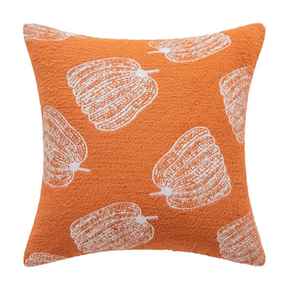 Orange pillow with white pattern on a white background. Cozy fall pumpkin pillow cover for living room or bedroom.