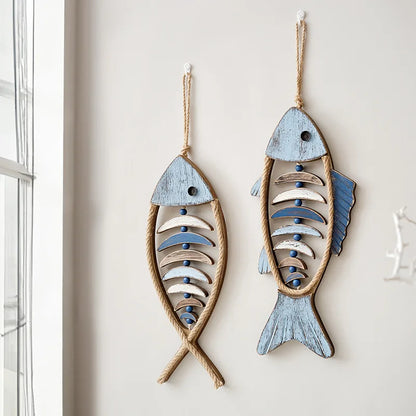 Two fish-shaped wall decorations with wooden and rope details on a light background boho home decor, coastal home accents, nautical wall hanging, wooden fish wall decor, Mediterranean decor, beach house decoration, rustic fish ornament, vintage boho living room decor, seaside wall art, summer housewarming gift