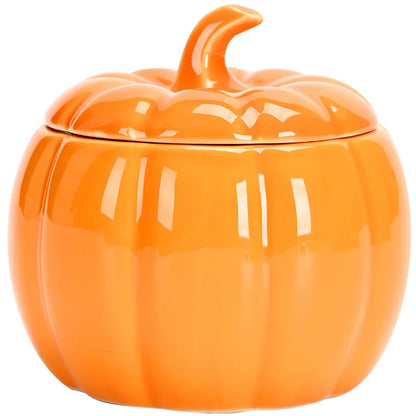 Orange ceramic pumpkin-shaped container on a white background. Ceramic pumpkin candy jar with lid, decorative fall tea jar or wedding gift container for home or halloween holiday decor.