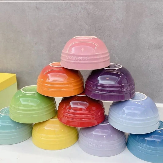 Stack of colorful plastic bowls on a gray background Gradient ceramic rice bowl in bright colors, bone china soup and noodle bowl, dessert and pudding kitchen tableware for boho home dining