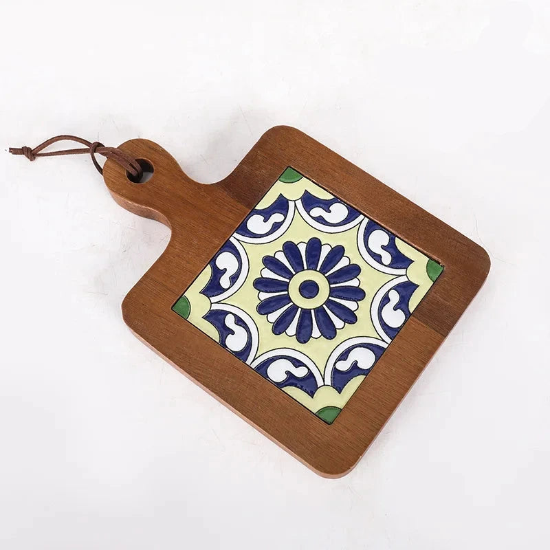 Wooden cutting board with decorative tile design on a white background
