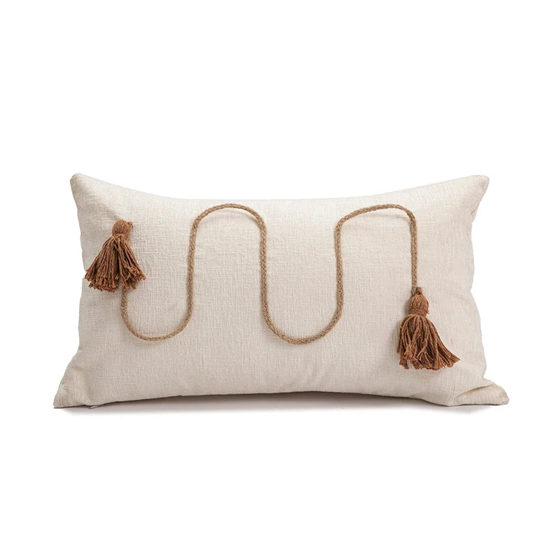 Decorative pillow with jute rope and tassels on a white background