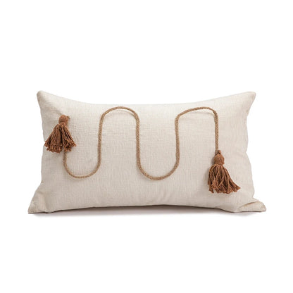 Decorative pillow with jute rope and tassels on a white background