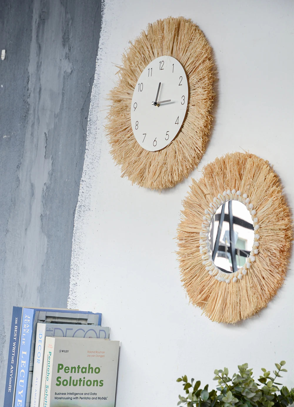 Two decorative wall mirrors with a clock on a white wall with books and a plant below. boho home decor, boho wall mirror, macrame wall mirror, nordic decor, romantic wedding wall decoration, housewarming gift, round straw mirror, woven wall decor, tapestry mirror, boho bedroom wall accent, rustic mirror wall hanging