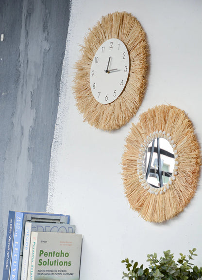 Two decorative wall mirrors with a clock on a white wall with books and a plant below. boho home decor, boho wall mirror, macrame wall mirror, nordic decor, romantic wedding wall decoration, housewarming gift, round straw mirror, woven wall decor, tapestry mirror, boho bedroom wall accent, rustic mirror wall hanging