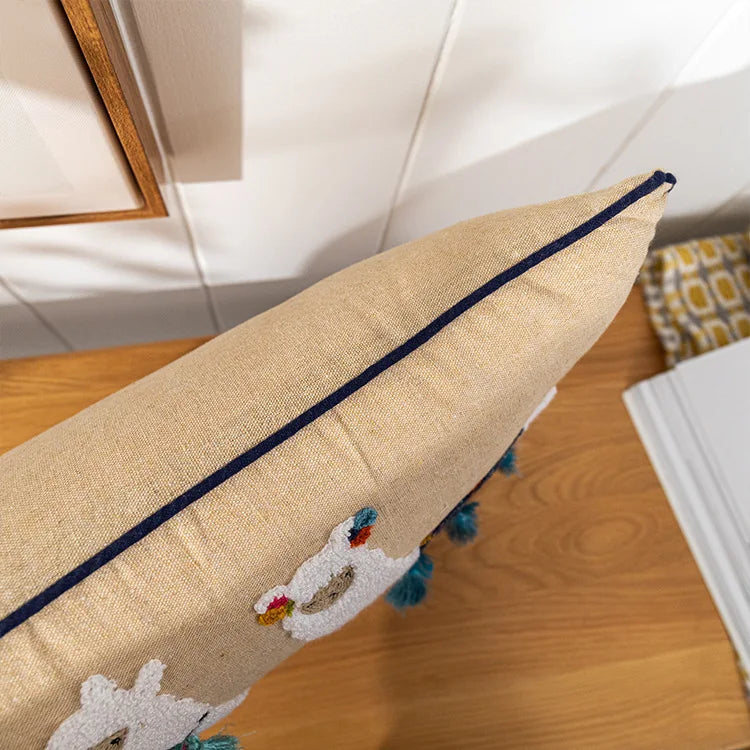 Decorative pillow with embroidered design on a wooden surface. Bohemian embroidered throw pillow cover with geometric design, cotton-blend cushion for sofa, bed, or modern home decor.