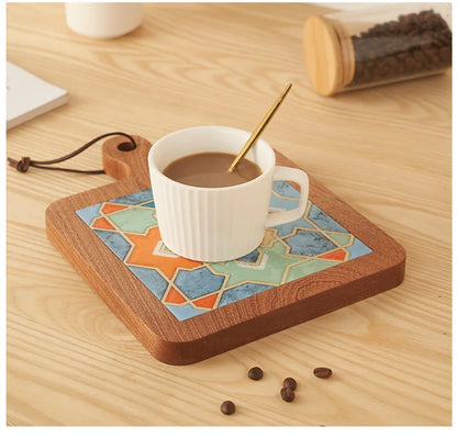 White mug with coffee on a decorative wooden coaster with geometric pattern, on a wooden surface with coffee beans.