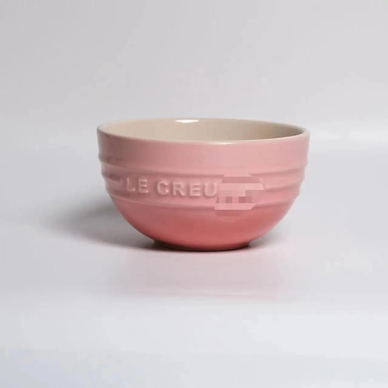 Pink ceramic bowl with 'LE CREU' branding on a light gray background Gradient ceramic rice bowl in bright colors, bone china soup and noodle bowl, dessert and pudding kitchen tableware for boho home dining