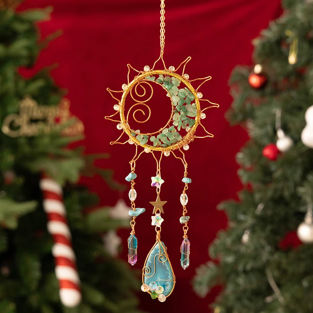 Decorative sun-shaped ornament with beads and stars hanging against a Christmas tree background. boho home decor, crystal wind chime, sun catcher for windows, moon prism chime, agate stone hanging, garden art decor, patio hanging decoration, boho housewarming gift, spiritual gift, crystal suncatcher, balcony decor, meditation decor, handmade crystal chime