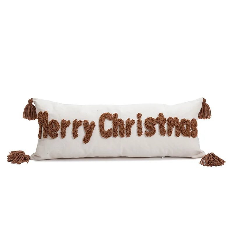 Decorative pillow with 'Merry Christmas' text and tassels on a white background