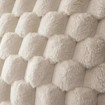 Close-up of textured beige fabric with a basketweave pattern