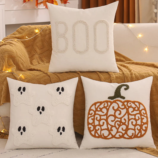 Three Halloween-themed decorative pillows Boo, ghosts, pumpkin on a couch with a warm, cozy background. Tufted Halloween pillow cover with pumpkin and ghost embroidery, 18x18 inch festive fall cushion case for sofa, bed, and seasonal boho farmhouse décor