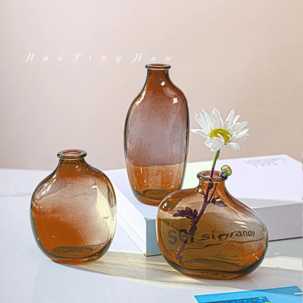 Three brown glass vases on a white surface with a light background from My Boho Home
