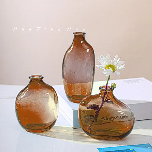 Three brown glass vases on a white surface with a light background from My Boho Home