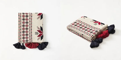 Two patterned pouches with tassels on a white background