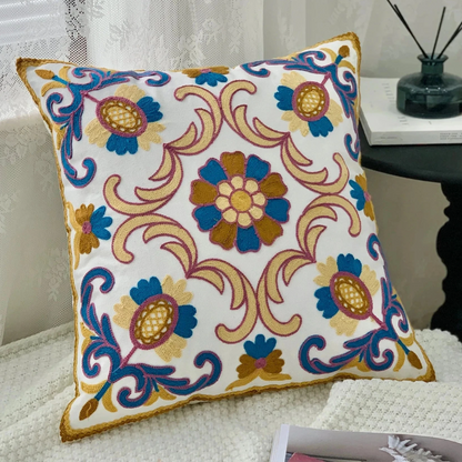 Decorative pillow with floral pattern on a couch, Handcrafted embroidered cushion cover on armchair – modern boho living room decor