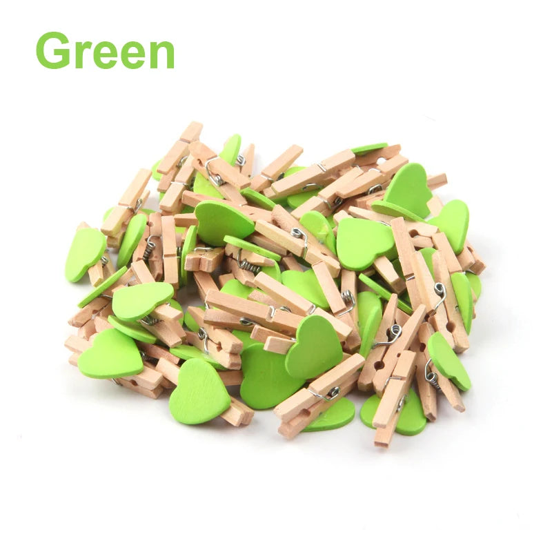Green heart-shaped clothespins on a white background