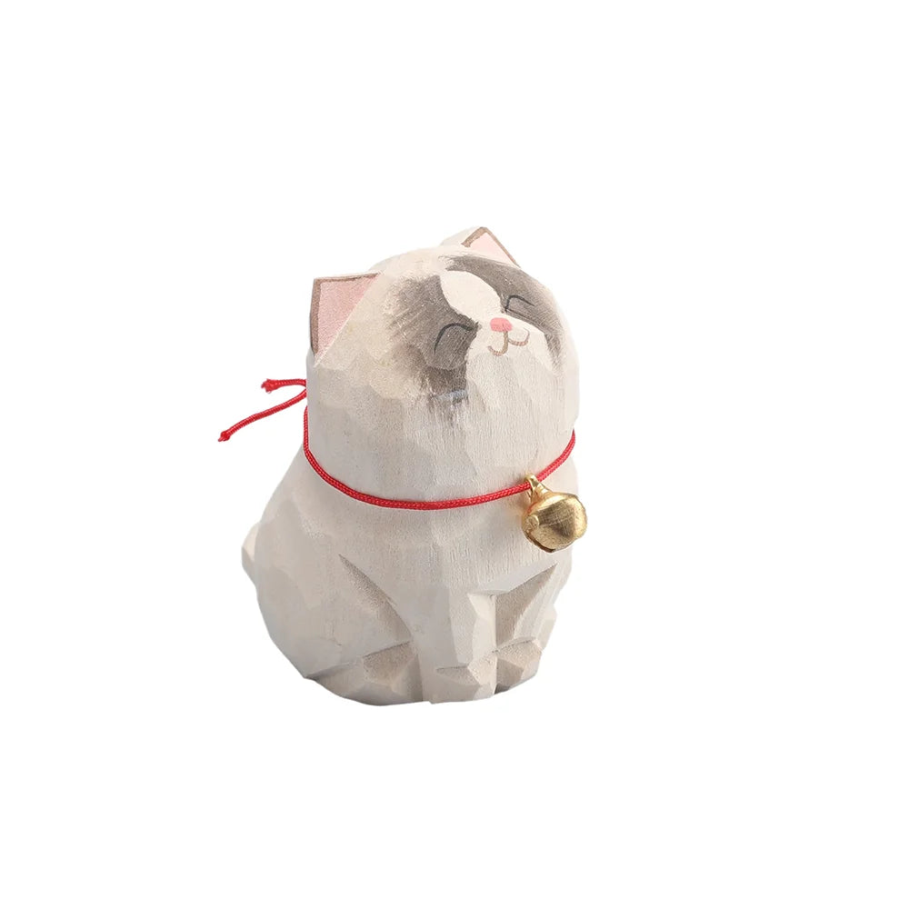 Cat-shaped incense burner with a red string and gold bell on a white background