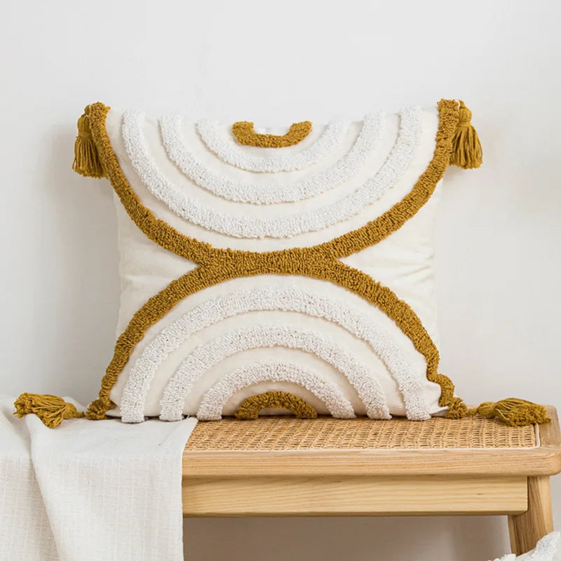 Decorative pillow with gold tassels on a wooden bench against a white background Nordic blue tufted cushion cover with geometric stripe and grid crochet pattern, tassel pillow cover for sofa, bed, and boho home decor