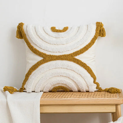 Decorative pillow with gold tassels on a wooden bench against a white background Nordic blue tufted cushion cover with geometric stripe and grid crochet pattern, tassel pillow cover for sofa, bed, and boho home decor