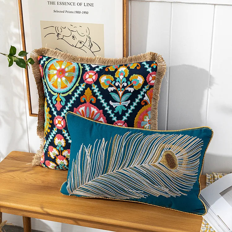 Decorative pillows with intricate patterns on a wooden surface. Bohemian embroidered throw pillow cover with geometric design, cotton-blend cushion for sofa, bed, or modern home decor.
