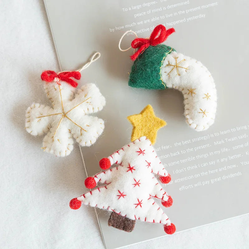 Three felt Christmas ornaments on a white surface with text.