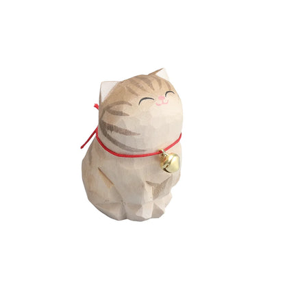 Cat-shaped decorative item with a bell on a white background