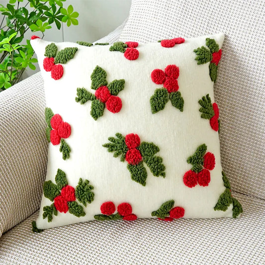 Decorative pillow with red and green patterns on a neutral background