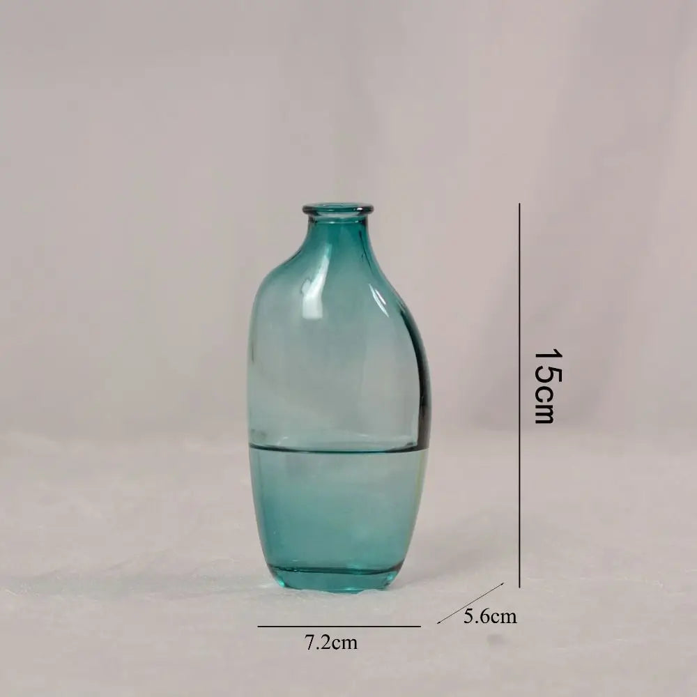 Teal glass vase with dimensions on a light gray background