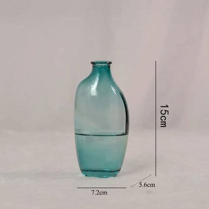 Teal glass vase with dimensions on a light gray background