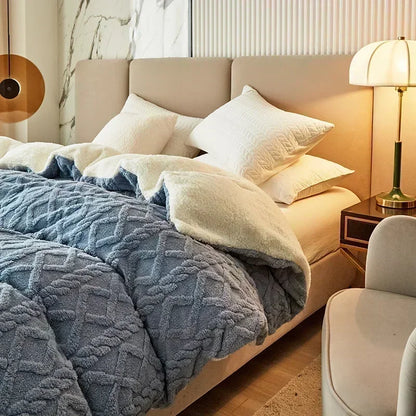 Neatly made bed with blue textured blanket and white pillows in a bedroom setting. Soft plush duvet cover and blanket in solid color with striped jacquard design, dual-use artificial cashmere fleece bedding for cozy winter warmth