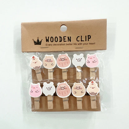 Packaged wooden clips with animal designs on a white background