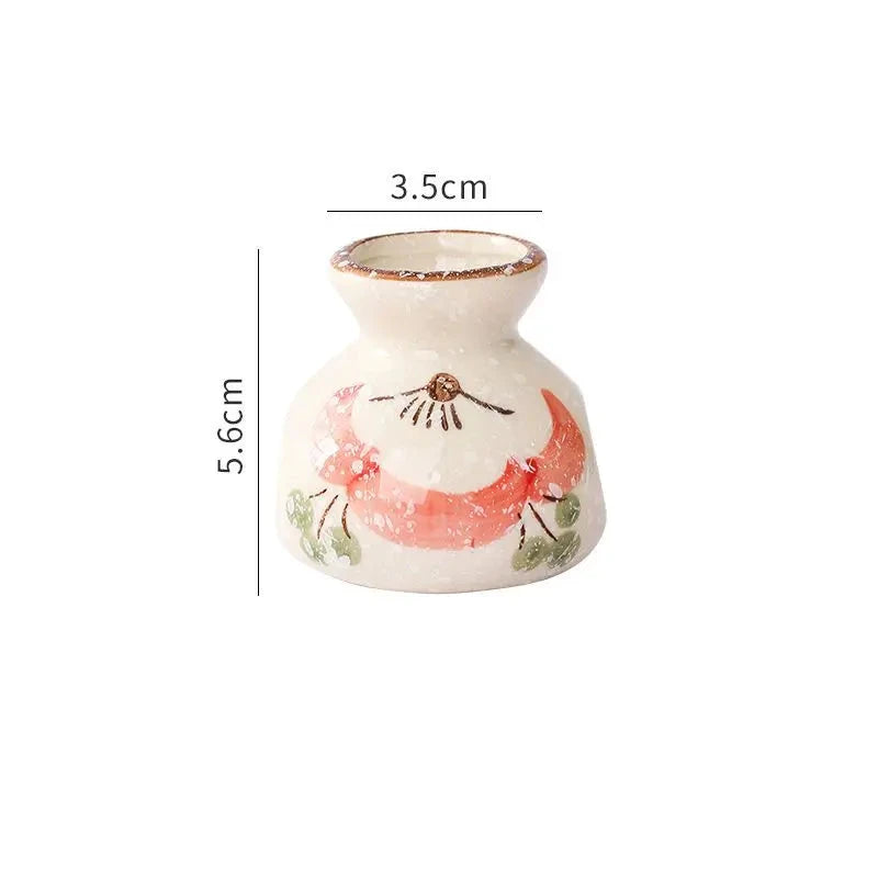 Small ceramic vase with floral design and measurements on a white background